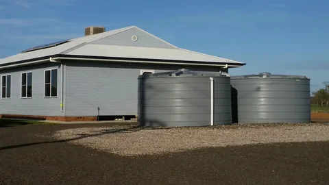 Rainwater storage tank installed beside a modern New Zealand home for efficient rainwater harvesting and sustainable water storage.
