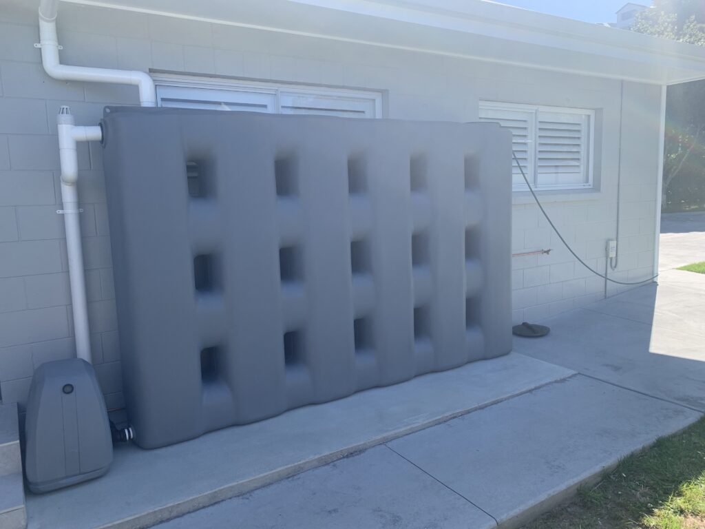 2000L Slate Grey StormPANEL slimline water tank installed with pump by Just Tanks