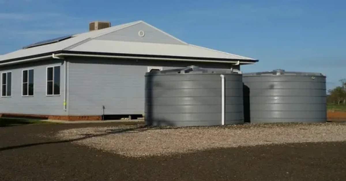 Rainwater storage tank installed beside a modern New Zealand home for efficient rainwater harvesting and sustainable water storage.